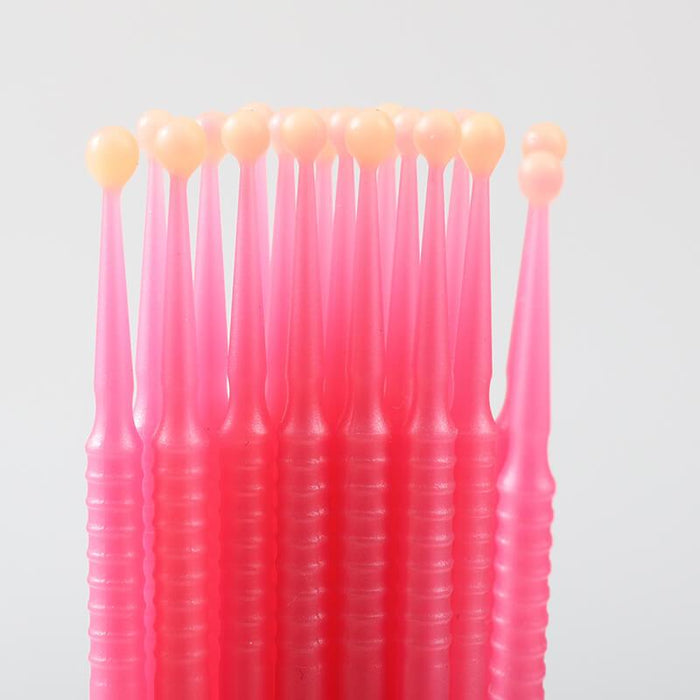 Disposable wax applicator brushes for tooth gem application