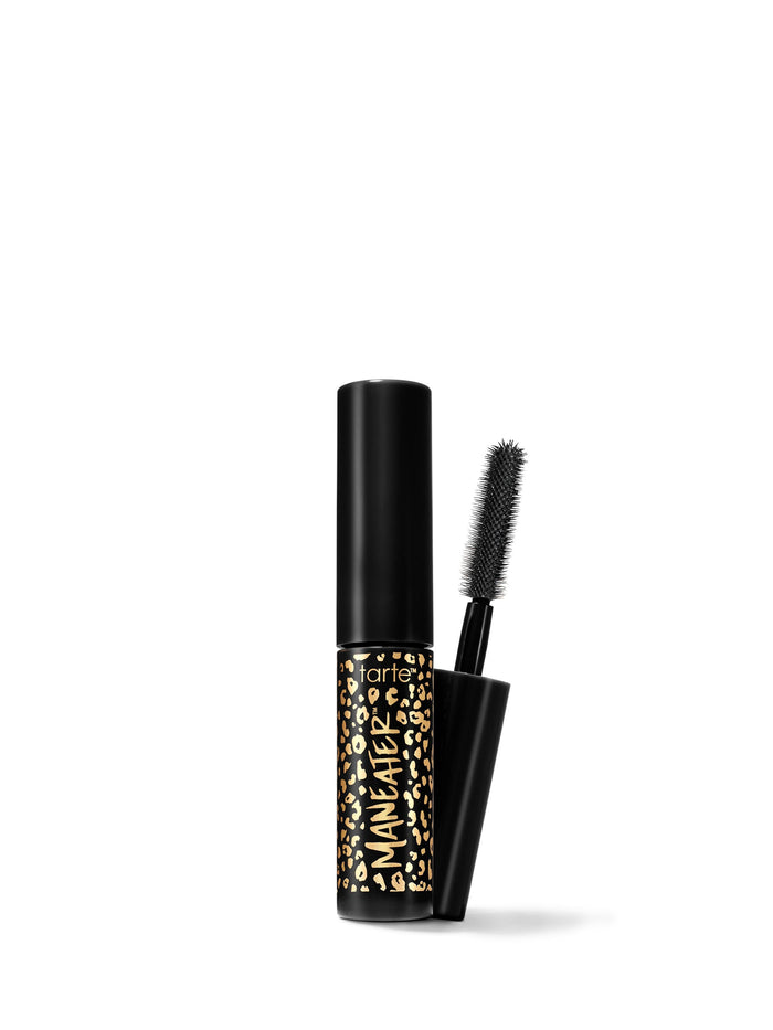A travel-size mascara with a black tube and a brush applicator, featuring a gold and black pattern on the tube.