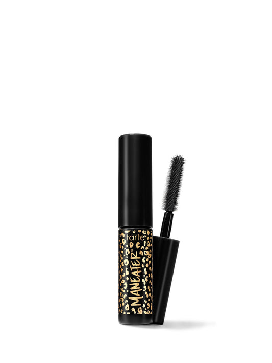 A travel-size mascara with a black tube and a brush applicator, featuring a gold and black pattern on the tube.