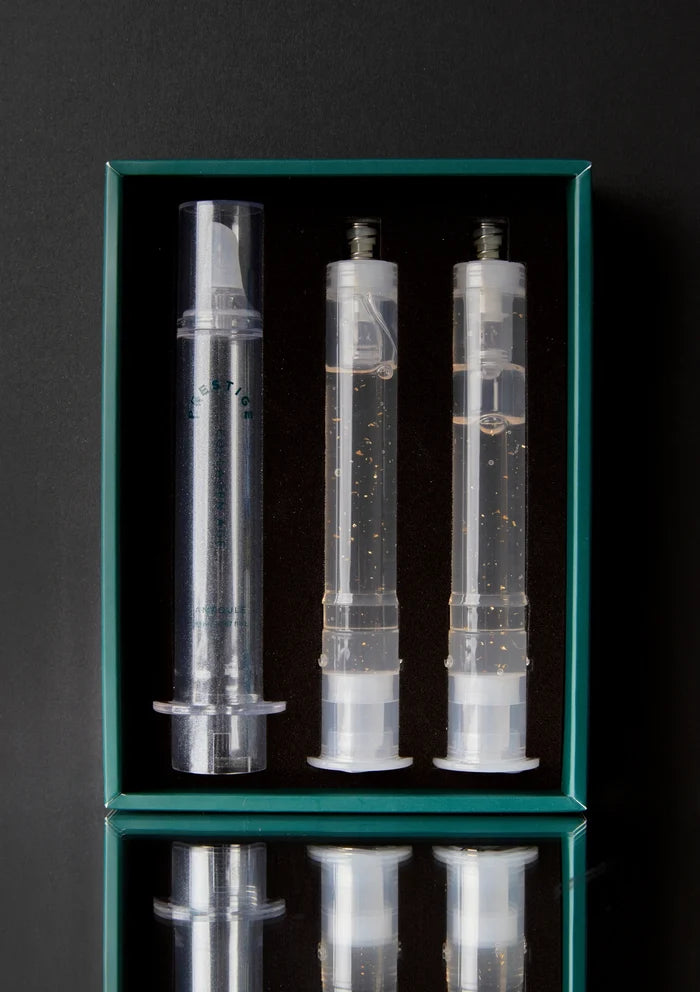 Three transparent syringes in a green box on a black background
