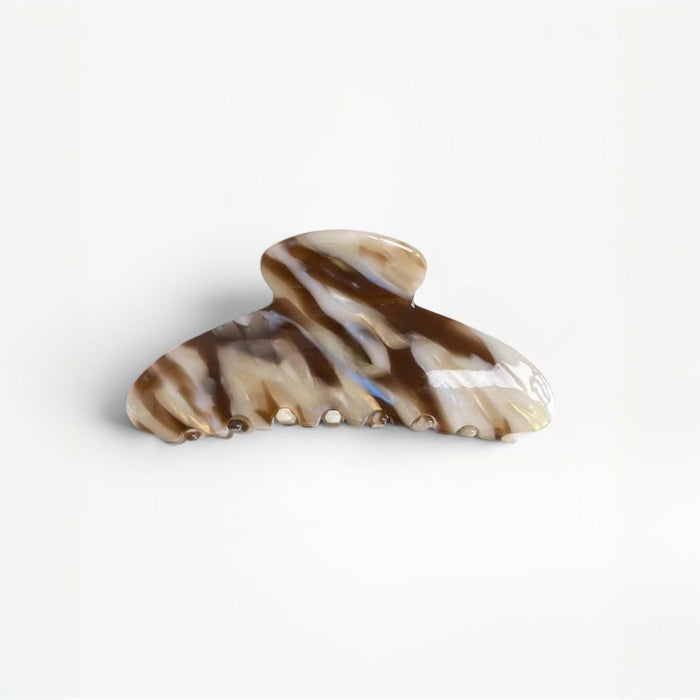Marbled patterned hair clip on a white background