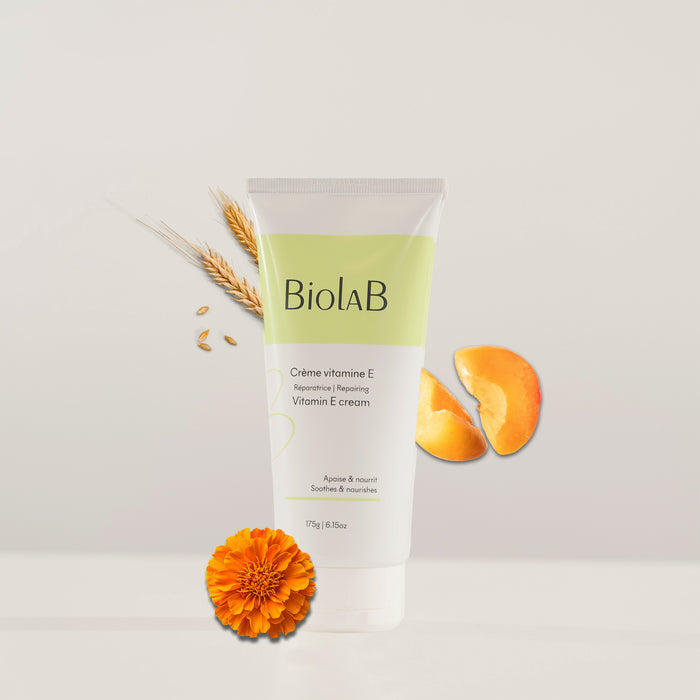 Biolab Vitamin E cream tube with apricot slices, wheat stalks, and marigold flower, soothing & nourishing skincare for all skin types